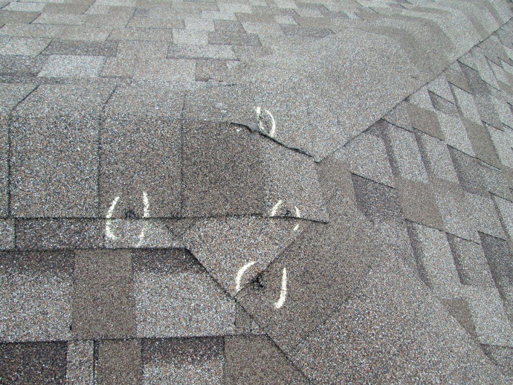 signs of hail damaged marked after roof inspection