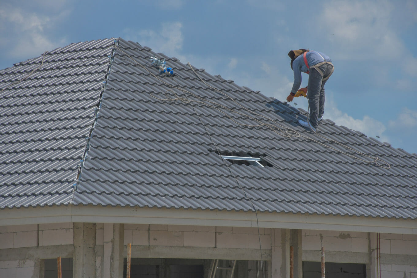a professional roofer gets up on the roof and checks to estimate the roof replacement cost