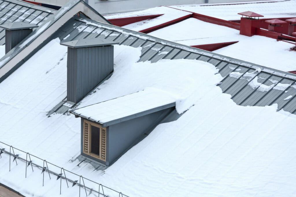 metal roof lifespan aerial view of snow covered metal roof