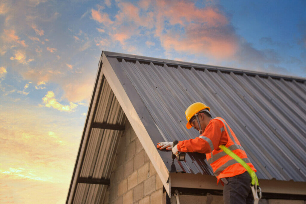 contractor completing metal roof repair