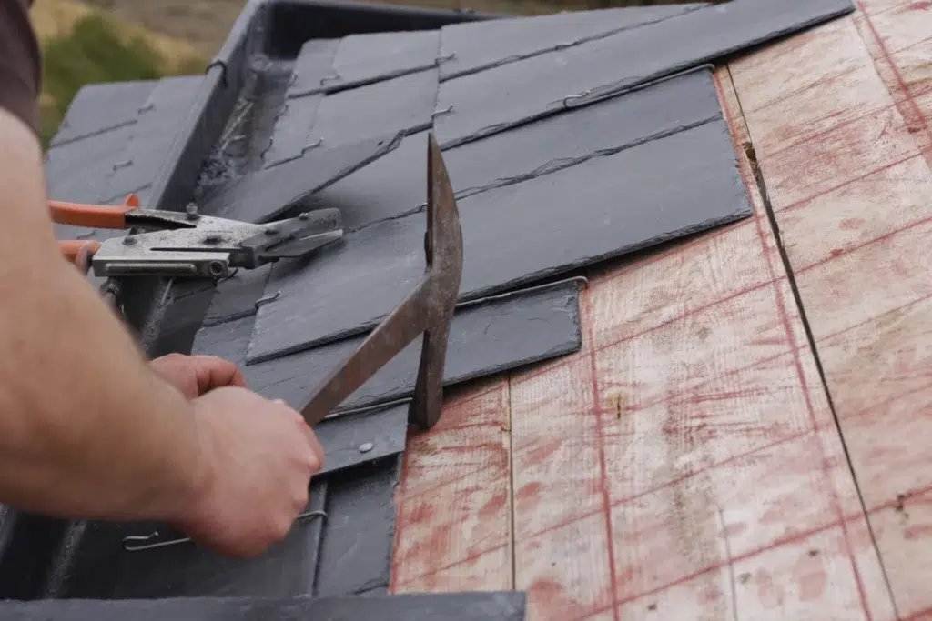 professional lines up slate roof tile for installation